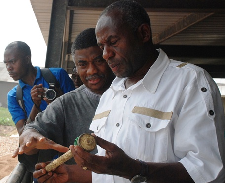 Alhaji Collins Dauda (right), Minister for Water Resources Works and Housing closely examining one of the spoilt filter plugs .With him is the Ag. Managing Director of the Ghana Urban Water Company, Mr. Senyo Amengor. 